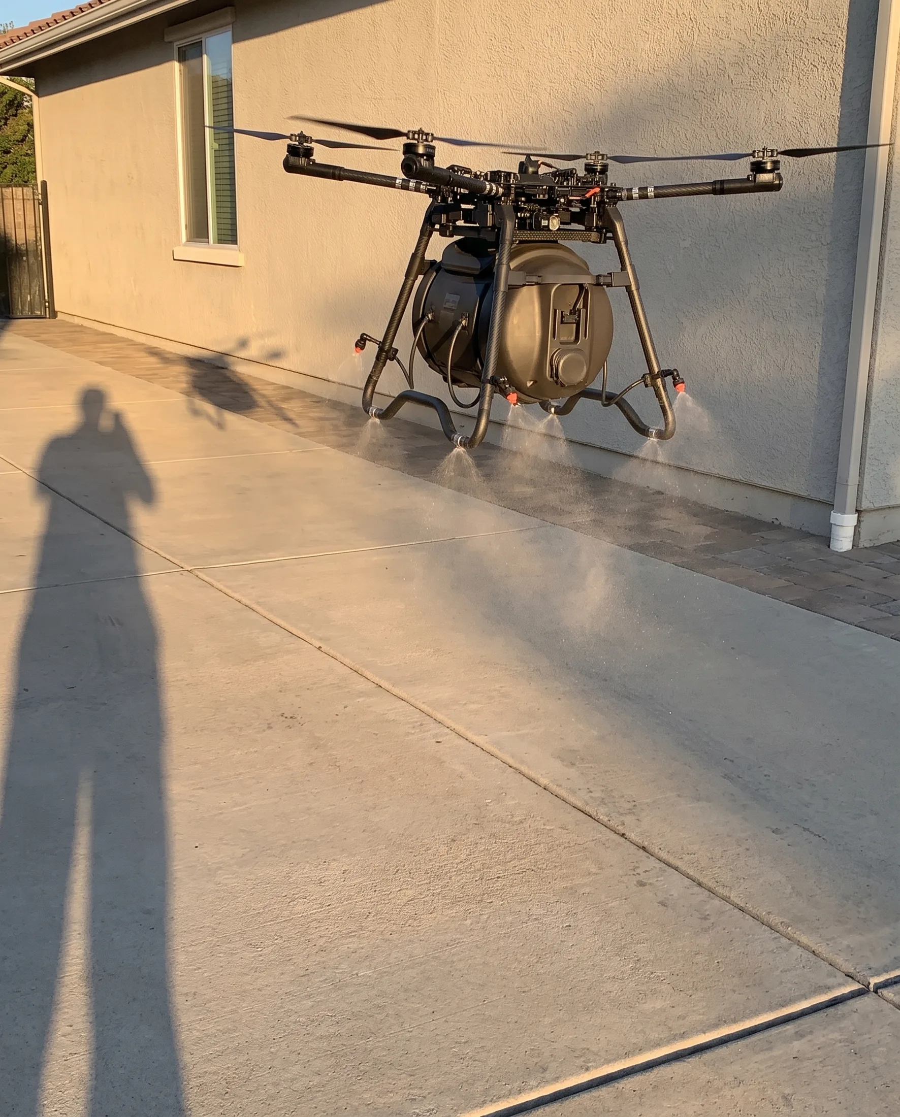 Sprayer covering a property, base station staged in the driveway